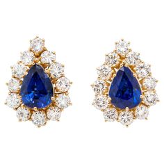 Expertly crafted in warm and radiant 18 carat yellow gold, these spectacular pear shaped stud earrings are a staple to every jewellery collection. Each earring features a captivating royal blue pear shape sapphire at its centre, weighing 4.84ct combined, radiating with deep, mesmerising hues that exude elegance with every movement. Surrounding the sapphires is a beautiful halo of 12 round brilliant cut diamonds, enhancing the beauty of the gemstones and creating a delightful contrast between the Luxury Pear-shaped Sapphire Earrings, Luxury Blue Pear-shaped Earrings, Formal Blue Pear-shaped Diamond Earrings, Blue Pear-shaped Diamond Earrings For Anniversary, Blue Pear-shaped Fine Jewelry Earrings, Sapphire Pear-shaped Fine Jewelry Earrings, Fine Jewelry Sapphire Pear-shaped Earrings, Yellow Gold Stud Earrings, French Clip