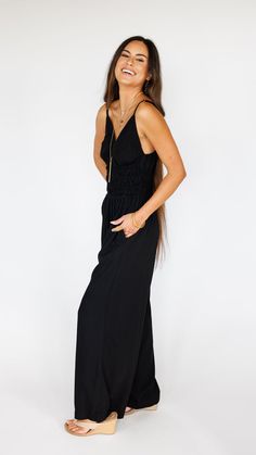 Stand out in this stunning jumpsuit, made to flow with buttery soft rayon and an exaggerated wide pant leg. Features adjustable straps and a gentle smocked waist to flatter. Fabric & Care Instructions:100% RayonHand wash cold Line dry Beach-ready Relaxed Fit V-neck Jumpsuit, Retail Boutique, Casual Jewelry, Wide Pants, Signature Jewelry, Solid Black, Fabric Care, Adjustable Straps, Care Instructions