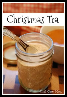 a glass jar filled with brown liquid and a spoon