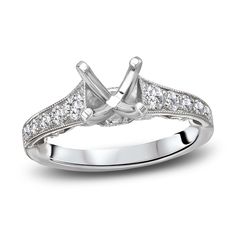 a white gold engagement ring with diamonds on it