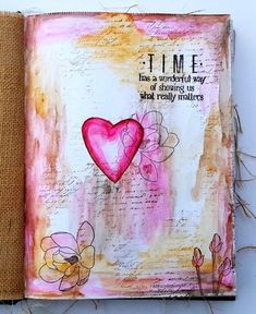 an altered book with pink hearts on it