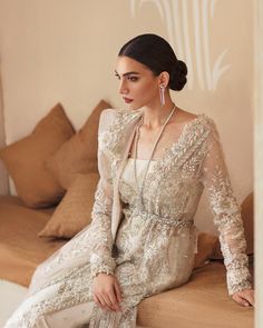 Elegant Pakistani Wedding Dress in Sharara Kameez Style is a breathtaking attire that gives you a dreamy appearance on a big day. Floral designs, embroidery, crystals, and cut-dana details make this stunning Pakistani Dress an epitome of beauty and your priority for the wedding. Kameez: The long kameez in premium organza fabric is gracefully emblazoned with lavish embroidery work. Traditional floral designs and threads give an elegant touch to the kameez. Cut-dana, pearls, crystals, and sequins Glamorous Wedding Dresses With Resham Embroidery, Glamorous Semi-stitched Wedding Dress, Anarkali Hand Embellished Wedding Dress, Anarkali Hand Embellished Wedding Dress For Ceremony, Hand Embellished Anarkali Wedding Dress, Eid Wedding Dress Hand Embellished Semi-stitched, Wedding Dress With Dupatta For Eid, Eid Hand Embellished Semi-stitched Wedding Dress, Glamorous Wedding Dress With Zari Work