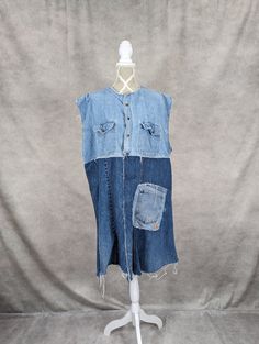 a mannequin wearing a blue jean dress with holes in the front and back