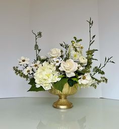 a vase filled with white flowers on top of a table