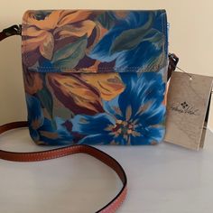 Nwt Patricia Nash Floral Leather Crossbody. Absolutely Gorgeous Crossbody. Shades Of Blue, Gold, Maroon And Green. Adjustable Leather Strap. Snap Closure. Inside Has 2 Separate Compartments W/1 Zip Compartment. Front Of Bag Has Additional Slide Compartment. Back Has Zip Compartment. Measures Approx 8” X 8”. Dust Bag Included. Blue Rectangular Flap Bag For Travel, Blue Flap Bag With Adjustable Strap For Travel, Blue Tote Flap Bag For Everyday Use, Blue Flap Bag For Everyday Use, Blue Satchel With Detachable Strap As Gift, Everyday Use Blue Flap Bag, Blue Leather Flap Bag For Everyday Use, Blue Travel Tote Flap Bag, Blue Leather Satchel As Gift