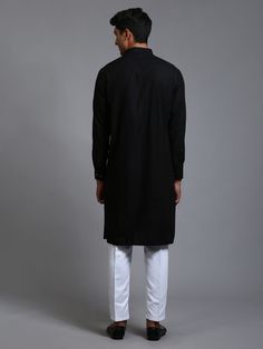 VM BY VASTRAMAY Men's Black Cotton Blend Kurta Pyjama Set Look stylish and comfortable in this classic black and white kurta pyjama set from VM BY VASTRAMAY. Made from a breathable cotton blend, this set features a black kurta with a mandarin collar, long sleeves, and button placket, paired with white churidar pants with a drawstring closure. Key Features Black cotton blend kurta with white cotton blend churidar Mandarin collar, long sleeves, button placket on kurta Drawstring closure on churidar pants Specifications Top Length: Knee-length Sleeve Length: Long Fit: Straight Material & Care Top Fabric: Cotton Blend Bottom Fabric: Cotton Blend Care: Dry clean only Legal Disclaimer: The product is guaranteed to be 100% genuine. Product images are for illustrative purposes only. Images/packagi Classic Cotton Sherwani For Eid, Casual Black Straight Kurta, Black Straight Kurta For Casual Wear, Classic Cotton Sherwani With Dabka Details, Casual Black Sets For Eid, Black Cotton Sherwani With Straight Kurta Shape, Black Cotton Sherwani With Long Sleeves, Luxury Black Cotton Kurta, Black Cotton Straight Kurta