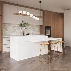 a kitchen with white counter tops and stools next to an island in the middle