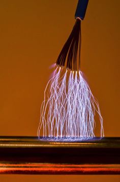 an electric wire is being used to make something blue and white with light streaks on it