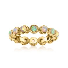 a yellow gold ring with white opal stones