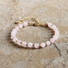 This gorgeous pink Rose Quartz gemstone bracelet features 18K gold filled accents. Stone: Rose Quartz Colour: Pink Main Stone Size: 6mm round  Metal: 18K Gold Filled Length: 19 - 24cm (with extension chain) I love making beautiful, handmade one-of-a-kind pieces of jewellery using semi-precious natural stones and crystals that can be treasured for a lifetime. I can customise a design specifically to meet your needs with your favourite semi-precious stones - ask about a custom design to match a special outfit or for your wedding or bridesmaids. Rose Gold Bracelets With Gemstone Round Beads, Rose Gold Bracelet With Round Gemstone Beads, Elegant Pink Faceted Crystal Bracelet, Elegant Pink Faceted Bracelet, Elegant Pink Round Beaded Bracelets, Gold Rose Quartz Bracelets For Jewelry Making, Elegant Rose Quartz Pink Crystal Bracelet, Pink Beaded Jewelry With 8mm Round Beads, Gold Bracelets With Rose Quartz And Natural Stones