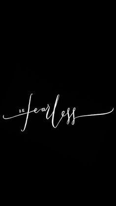 the word fearless written in cursive writing on a black background with white ink