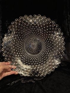 a person holding a glass plate with circles on it