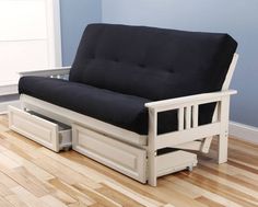 a futon bed with pull out drawers in the middle of a hardwood floored room