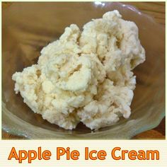 a bowl filled with ice cream sitting on top of a wooden table next to a sign that says apple pie ice cream