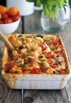 a casserole dish with tomatoes and other vegetables