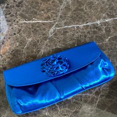 Brand New Evening Bag/Clutch In Blue With Flower On Top. Short Silver Chain To Use As Bag Elegant Blue Shoulder Bag Clutch, Blue Clutch With Removable Pouch For Party, Blue Pouch Clutch For Events, Blue Pouch Clutch For Formal Occasion, Blue Evening Bag With Removable Pouch For Party, Blue Pouch Bag For Events, Blue Clutch Bag For Formal Occasions, Elegant Blue Pouch Bag, Elegant Blue Clutch Shoulder Bag