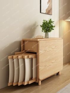 a plant is sitting on top of a wooden cabinet next to a white rug and wall