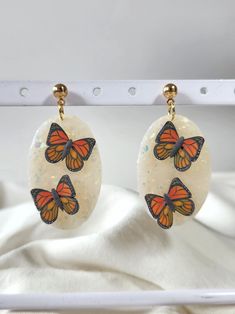 These monarch butterfly dangle stud earrings are made from semi-translucent polymer clay with opalescent accents. They have stainless steel alloy ball stud backings and are 1in wide x 2in tall. Monarch Butterfly, Philadelphia Pa, Jewelry Earrings Dangle, Dangle Drop Earrings, Polymer Clay, Dangle Earrings, Handmade Items, Jewelry Earrings, Stud Earrings