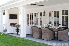 an outdoor dining area with wicker chairs and white tablecloths on the patio