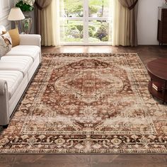 a living room with a large rug on the floor and a couch in front of it