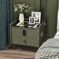 a bedroom with a bed, nightstand and pictures on the side table next to it