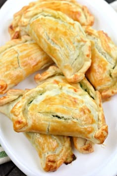 several puff pastry items on a white plate