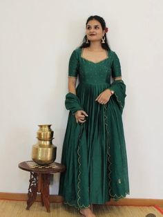 Hand embroidered Anarkali with hand embroidered / anarkali suit set / hand embroidery anarkali gown USA / green designer wedding dress with embroidery / Indian dresses/ voggish / green pure silk  dress         Looking for a perfect indian dress/anarkali/suit sets that are trendy, unique and easy to carry !! yess, You are at the right place. we carry such versatile pieces of anarkalis and suit sets that really let you stand out in any occassion !!      featuring this beautiful anarkali dress in dark green color with simple hand embroidery at the front body part with elbow sleeves as shown made with pure chanderi with heavy gear as shown paired with matching scallop embroidered Kota dupatta !! A very classy, beautiful look makes your occasion Perfect !! Ready to ship !!  Details :  - color : Dark Green Anarkali Dress, Green Floor-length Kurta With Cutdana Detail, Green Floor-length Kurta With Cutdana, Green Floor-length Cutdana Kurta, Pista Green Anarkali Kurta Floor-length, Festive Green Floor-length Churidar, Green Anarkali Set With Traditional Drape, Green Anarkali Set For Navratri Designer Wear, Designer Green Anarkali Set For Navratri