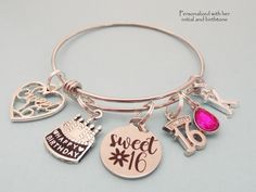 "16th Birthday Gift for Girl Our sweet 16 personalized charm bracelet- comes with all charms shown, you just select the initial and birthstone you need. Ships within two business days from Bangor, Maine The bangle is adjustable to fit most wrist sizes and is made of jewelry grade stainless steel. Stainless steel bracelets are always our choice for expandable bracelets. Stainless steel ensures your bracelet will never tarnish or lose it's color - it's also easy to care for. Just a quick polish wi Hypoallergenic Charm Bracelet For Birthday And Mother's Day, Hypoallergenic Charm Bracelet For Birthday And Valentine's Day, Personalized Charm Bracelet For Birthday And Valentine's Day, Hypoallergenic Charm Bracelet For Birthday, Customizable Pink Charm Bracelet For Birthday, Birthday Round Charm Bracelet, Silver Name Charm Bracelet For Birthday, Silver Name Bracelet For Birthday, Silver Jewelry For Sweet 16 And Valentine's Day