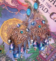 "These Victorian Filigree Chandelier Earrings are made with *Peacock Teal crystal and ornate layered brass filigrees. A Swarovski rhinestone decorates the surface of the filigrees for an added sparkle! Available with Posts, Clip-Ons or French Wires. The pictures show the post version. If french wire are chosen this top Aqua stone will be omitted from the design. -3 1/2\" Long x 1 3/8\" Wide -0.3 oz. ea. -Free Ship! (Domestic) -Many Colors Available! *Comes Ready To Gift in Decorative Packaging * Ornate Chandelier Earrings, Luxury Traditional Filigree Chandelier Earrings, Luxury Victorian Chandelier Earrings, Victorian Gold Filigree Chandelier Earrings, Antique Filigree Dangle Chandelier Earrings, Ornate Jewelry, Aqua Stone, French Wire, Rhinestone Jewelry