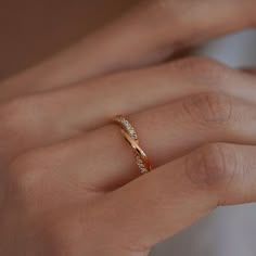 a woman's hand with a diamond ring on it