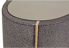 a close up of a round table with a wooden stick sticking out of it