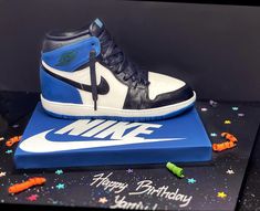 a birthday cake made to look like a shoe on top of a blue and white box