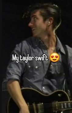 a man holding a guitar in his right hand with the words my taylor swift on it