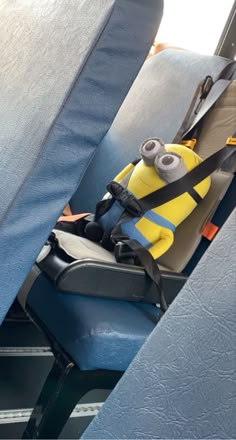 a minion sitting in the back seat of a bus