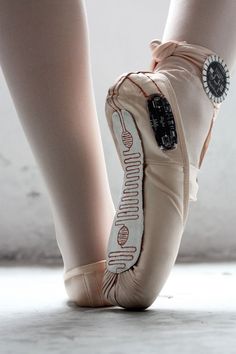 the feet of a person in ballet shoes