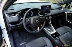 the interior of a car with black leather seats and steering wheel, dashboard controls, and dash board