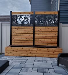 a wooden bench sitting on top of a stone patio