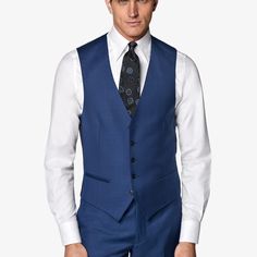 Mid blue waistcoat with a slim fit, featuring a V-neck collar, jetted pockets, single-breasted 5-button closure, and a rear cinch for an adjustable fit. Elegant Blue V-neck Vest, Blue Three-piece Suit With Notch Lapel And Pockets, Blue Three-piece Suit With Notch Lapel, Formal Blue V-neck Outerwear, Blue Three-piece Suit With Welt Pockets For Work, Business Vest With Pockets And V-neck, Fitted Blue Three-piece Suit With Pockets, Blue Sleeveless Suits For Formal Occasions, Blue Fitted Three-piece Suit