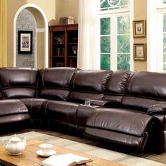 a brown leather sectional sofa in a living room