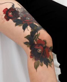 a woman's arm with flowers on it