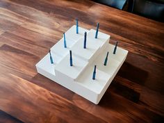 several toothpicks are placed in the shape of squares on a wooden table top