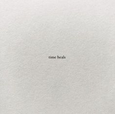 the word time heals written in white paper