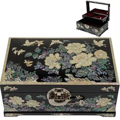 an ornate black box with flowers and butterflies on it