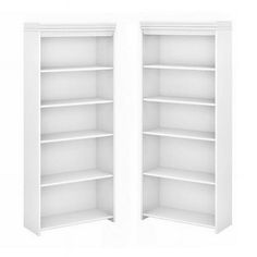 two white bookcases with open doors on each side, one is empty and the other has no shelves