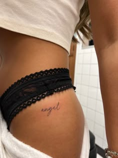 Angle Word Tattoos, Angel Tattoo On Hip, Small Tattoo Areas For Women, Women Tattoos Hip, Hip Tattoos Women Writing, Name On Hip Tattoo, Upper Thigh Word Tattoo, Hip Small Tattoos Women, Script Hip Tattoo