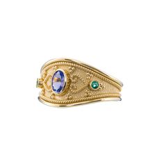 A gold ring featuring an enchanting oval tanzanite, two round emeralds, and intricate Byzantine-era details--an exquisite blend of history and elegance that graces your hand with enduring allure. 100% handmade in our workshop. Metal: 14K Gold| 18K Gold Gemstones: Tanzanite oval | weight 0,35 ct  Emerald round | weight 0,05 ct Discover the art of personalization as you select your dream jewelry, choosing the perfect gemstone that resonates with your unique style. Our dedicated team is always read Elegant Oval Ring With Historical Design, Byzantine Gold, Byzantine Rings, Medieval Rings, Ancient Beauty, Etsy Gold Ring, Tanzanite Ring, Local Jewelry, Dream Jewelry