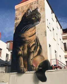 a large cat painted on the side of a building