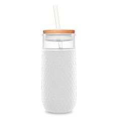 a glass cup with a straw in it and a wooden lid on the top, sitting against a white background