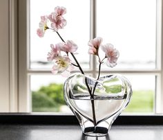 a glass vase with some flowers in it