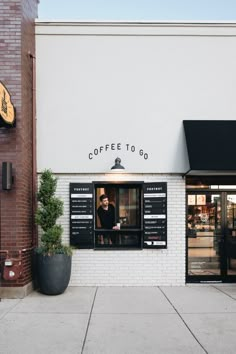 a man sitting in the window of a coffee shop